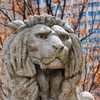 A grey stone statue of a lion